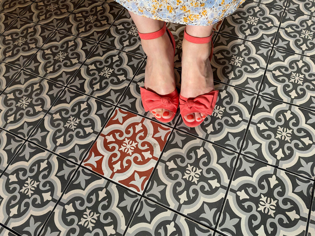 SweedItaly lifestyle image showing a pair of shoes against a tiled floor.