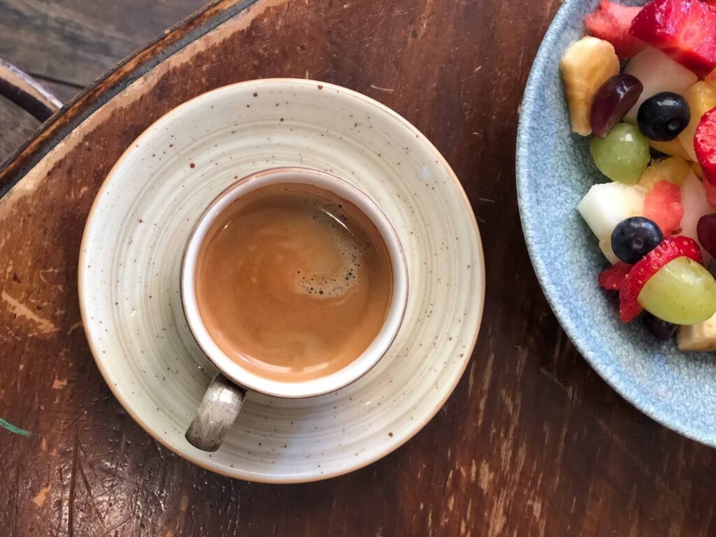 Cup of freshly brewed chicory coffee served on a rustic wooden table, a naturally caffeine-free coffee alternative.